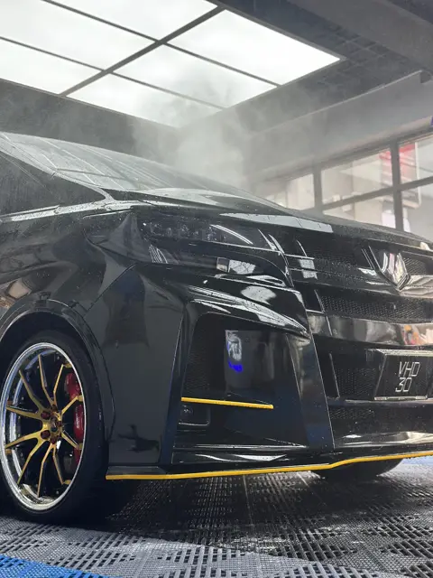 Snow foam pre-wash on a dark sports car