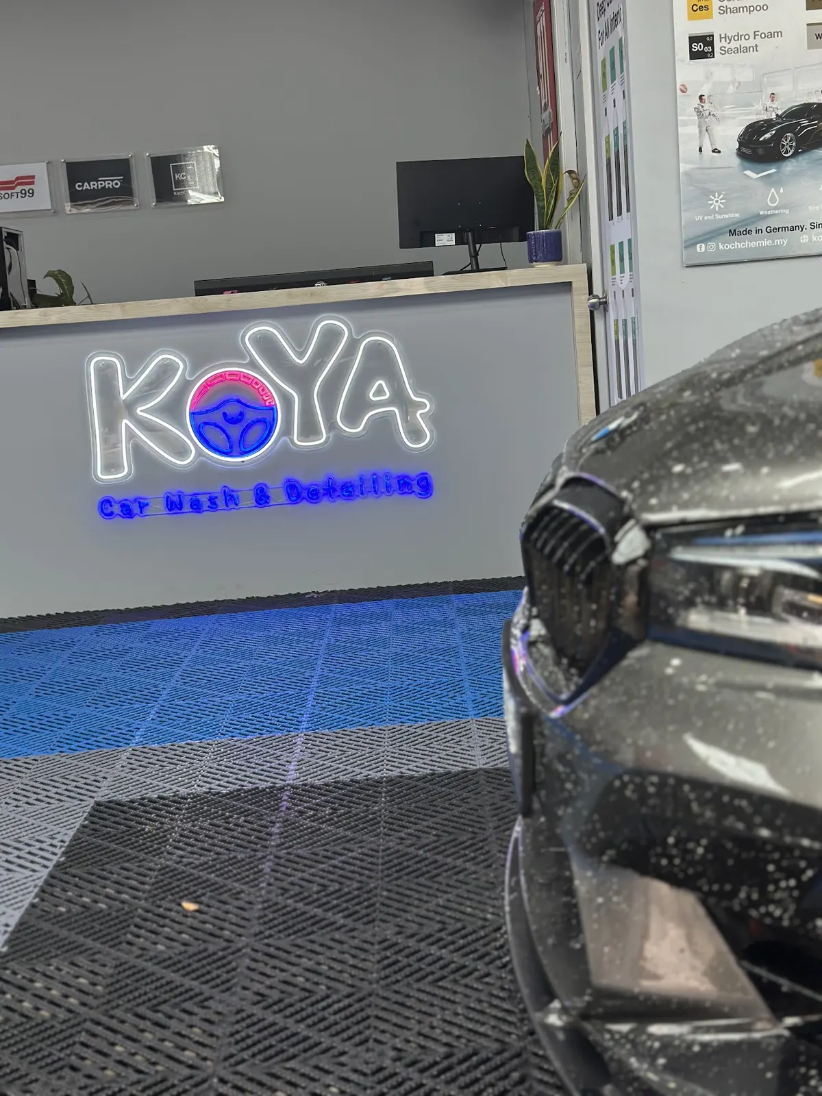 Snow foam on BMW headlamp in front of KOYA counter
